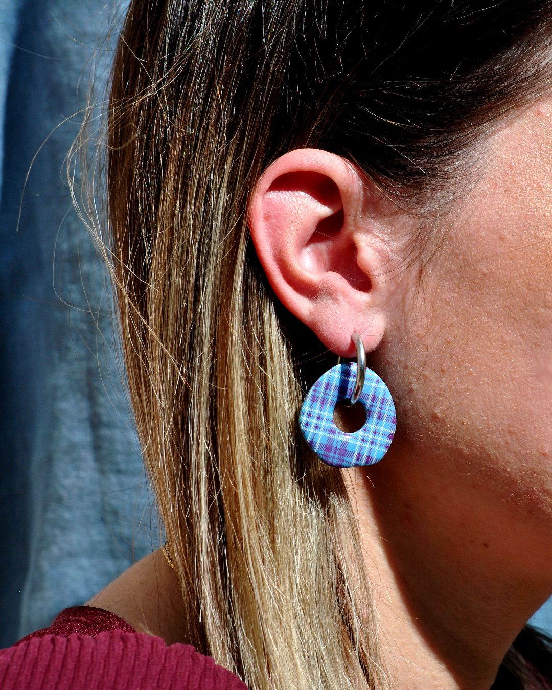 Boucle d'oreille portée avec créole argentée.