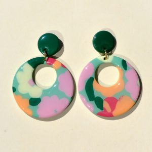 Paire de boucles d'oreilles en forme de rond rétro, ajourée, au motif floral printanier, surmontée d'une puce ronde unie vert foncé.